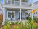 Charming front porch with chairs, plants, and curb appeal enhances this home's inviting exterior at 886 Clay Field Trl, Summerville, SC 29485