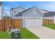 Attached one car garage featuring a white door and blue siding at 886 Clay Field Trl, Summerville, SC 29485