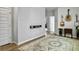 Stylish hallway with a decorative rug, floating shelf, and modern musical instruments at 886 Clay Field Trl, Summerville, SC 29485