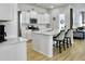 Bright kitchen with white cabinets, a large island, and stainless steel appliances at 886 Clay Field Trl, Summerville, SC 29485