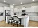 Bright kitchen with white cabinets, a large island, and stainless steel appliances at 886 Clay Field Trl, Summerville, SC 29485