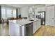 Bright kitchen with white cabinets, a large island, and stainless steel appliances at 886 Clay Field Trl, Summerville, SC 29485