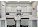 Bright kitchen with white cabinets, a large island, and stainless steel appliances at 886 Clay Field Trl, Summerville, SC 29485