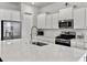 Bright kitchen with white cabinets, a large island, and stainless steel appliances at 886 Clay Field Trl, Summerville, SC 29485