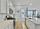 Bright kitchen with white cabinets, a large island, and stainless steel appliances at 886 Clay Field Trl, Summerville, SC 29485