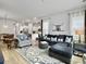 Open-concept living area showcasing comfortable seating, an area rug, and bright lighting throughout at 886 Clay Field Trl, Summerville, SC 29485