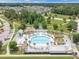 Aerial view of a luxurious community pool area with palm trees and lounge chairs at 886 Clay Field Trl, Summerville, SC 29485