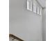 Bright wall detail of a staircase, highlighting small accent windows at 886 Clay Field Trl, Summerville, SC 29485