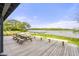 Inviting back porch with picnic tables and benches overlooking the water and a boat dock at 9822 Haven Loop, Johns Island, SC 29455