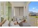 Charming balcony with comfortable wicker furniture, and views of the neighborhood at 9822 Haven Loop, Johns Island, SC 29455