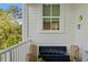 Relaxing balcony with a modern fountain, white railings, and views of the surrounding trees at 9822 Haven Loop, Johns Island, SC 29455