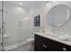 Modern bathroom featuring a glass-enclosed shower, sleek vanity with dark wood cabinets, and chic geometric wallpaper at 9822 Haven Loop, Johns Island, SC 29455