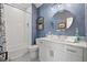 Bright bathroom features blue accent wall, white subway tile in shower, hexagon tile floors and modern vanity at 9822 Haven Loop, Johns Island, SC 29455
