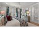 Bright bedroom with stylish blue bedding and a light blue dresser next to the open bathroom at 9822 Haven Loop, Johns Island, SC 29455