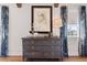 Bedroom dresser with gold handles, lamp, and blue floral curtains with outside view at 9822 Haven Loop, Johns Island, SC 29455