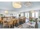 Bright common area with comfortable seating and tables for relaxing and socializing at 9822 Haven Loop, Johns Island, SC 29455