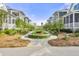 Beautiful community with manicured landscaping, sidewalks, and charming homes in the background at 9822 Haven Loop, Johns Island, SC 29455