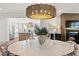 Open dining area with marble table, modern lighting, adjacent to a bright kitchen, creating a seamless flow at 9822 Haven Loop, Johns Island, SC 29455