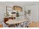 Bright dining room with modern chandelier, marble table, and artistic decor creating an elegant atmosphere at 9822 Haven Loop, Johns Island, SC 29455
