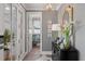 Elegant entryway with patterned wallpaper, chic decor, and view to a bright room, creating a stylish welcome at 9822 Haven Loop, Johns Island, SC 29455