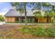 Stunning exterior view of a modern home with wood siding, black-framed windows, and a metal roof at 9822 Haven Loop, Johns Island, SC 29455