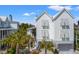 Stunning exterior of a white two-story home with palm trees at 9822 Haven Loop, Johns Island, SC 29455