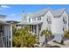 Elegant exterior of a bright home with grey metal roof and palm trees at 9822 Haven Loop, Johns Island, SC 29455