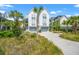 Charming home with palm trees, a two-car garage, and lush landscaping at 9822 Haven Loop, Johns Island, SC 29455