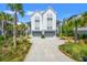 Beautiful home with palm trees, a two-car garage, and driveway at 9822 Haven Loop, Johns Island, SC 29455