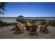 Inviting fire pit with Adirondack chairs overlooking a pier and bay at 9822 Haven Loop, Johns Island, SC 29455