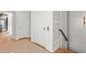 Hallway with hardwood floors, neutral walls, wood beam, and white doors leading to other areas of the home at 9822 Haven Loop, Johns Island, SC 29455