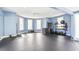 Bright home gym featuring rubber flooring, blue walls, recessed lighting and an assortment of workout equipment at 9822 Haven Loop, Johns Island, SC 29455
