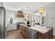 Open kitchen with a wooden island, updated stainless steel appliances, and natural light at 9822 Haven Loop, Johns Island, SC 29455