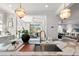Kitchen island with a bronze faucet and stainless steel sink overlooking a living space at 9822 Haven Loop, Johns Island, SC 29455