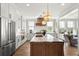 Bright kitchen with a large island, stainless appliances, and access to other living spaces at 9822 Haven Loop, Johns Island, SC 29455