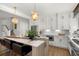 Bright, updated kitchen with a marble island, stainless appliances, and modern hanging lights at 9822 Haven Loop, Johns Island, SC 29455