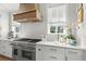 Updated kitchen featuring stainless steel appliances, tile backsplash, and light-filled windows at 9822 Haven Loop, Johns Island, SC 29455