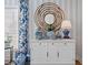 Stylish living room featuring blue patterned curtains, and a decorative cabinet with blue and white vases at 9822 Haven Loop, Johns Island, SC 29455