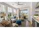 Bright living room with a sliding glass door to a private balcony, hardwood floors, and nice furnishings at 9822 Haven Loop, Johns Island, SC 29455