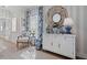 Stylish living room featuring blue patterned curtains, an ornate chair, and a decorative cabinet with vases at 9822 Haven Loop, Johns Island, SC 29455