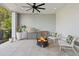 Outdoor patio with stainless steel BBQ, fire pit, ceiling fan, and comfortable seating at 9822 Haven Loop, Johns Island, SC 29455