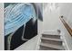 Staircase with grey carpet and a painting hanging on the wall at 9822 Haven Loop, Johns Island, SC 29455