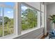 Window showcasing a scenic backyard view with lush greenery and a clear blue sky at 9822 Haven Loop, Johns Island, SC 29455