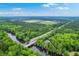 Expansive aerial view of home, bridge and river, with wooded surroundings under a blue sky at 100 Canal Rd, Saint George, SC 29477