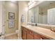 Well-lit bathroom featuring a large mirror, vanity with storage, and neutral-toned walls at 100 Canal Rd, Saint George, SC 29477