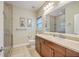 Bright bathroom featuring neutral tile, vanity, and a glass-enclosed shower at 100 Canal Rd, Saint George, SC 29477