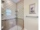 Glass-enclosed shower with detailed tilework, showerhead, and a built-in shelf at 100 Canal Rd, Saint George, SC 29477