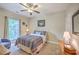 Cozy bedroom with a ceiling fan, natural light from a large window, and comfortable decor at 100 Canal Rd, Saint George, SC 29477