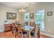 A dining room featuring lots of natural light, wood table, and classic chandelier at 100 Canal Rd, Saint George, SC 29477