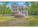 Charming two-story home with a welcoming front porch, complemented by well-maintained landscaping and a serene natural backdrop at 100 Canal Rd, Saint George, SC 29477